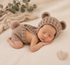 A sleeping newborn baby wearing a knitted brown bear-ear bonnet and matching diaper cover, posed on a soft cream blanket with a small knitted heart prop nearby.



newborn bear outfit, newborn photography, newborn photo prop, baby bear outfit, teddy bear outfit, newborn romper, knit baby romper, newborn boy outfit, newborn girl outfit, gender neutral baby, newborn photoshoot, baby photo outfit, bear ear hat, newborn bonnet, knit newborn outfit, newborn gift, baby shower gift, birth announcement outfit, newb