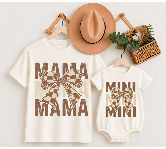 A matching mother-and-child t-shirt and bodysuit set in cream, featuring brown and beige plaid bow graphics and the words &