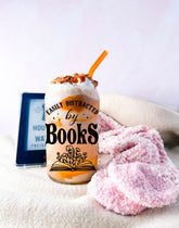 Clear handmade Libbey glass cup with "Easily Distracted by Books" text and open book design, filled with iced coffee and. - Distracted by Books Floral Libbey Glass Cup