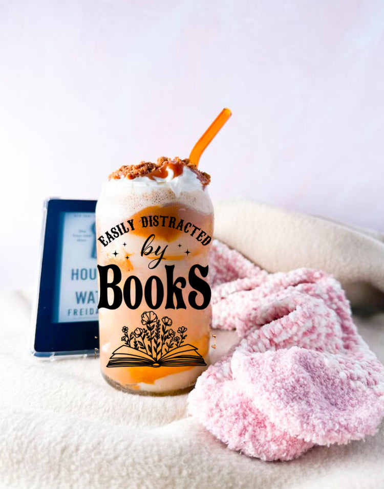 Clear handmade Libbey glass cup with "Easily Distracted by Books" text and open book design, filled with iced coffee and. - Distracted by Books Floral Libbey Glass Cup