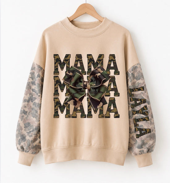 A beige crewneck sweatshirt hanging on a wooden hanger against a white background. The sweatshirt features &